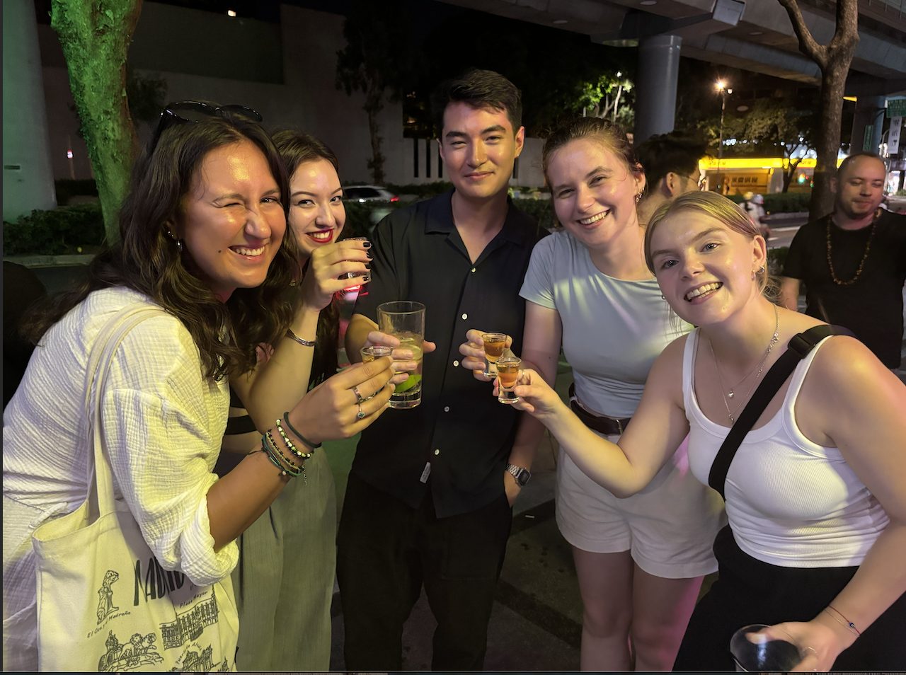 An international group toasting outdoors on a Friday night in Taipei